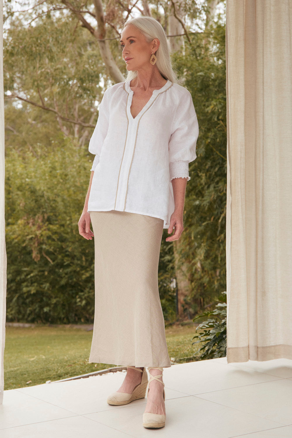 Model wearing the Katie Bias Cut Linen Skirt in Natural with hidden elastic waistband, Adrift Clothing