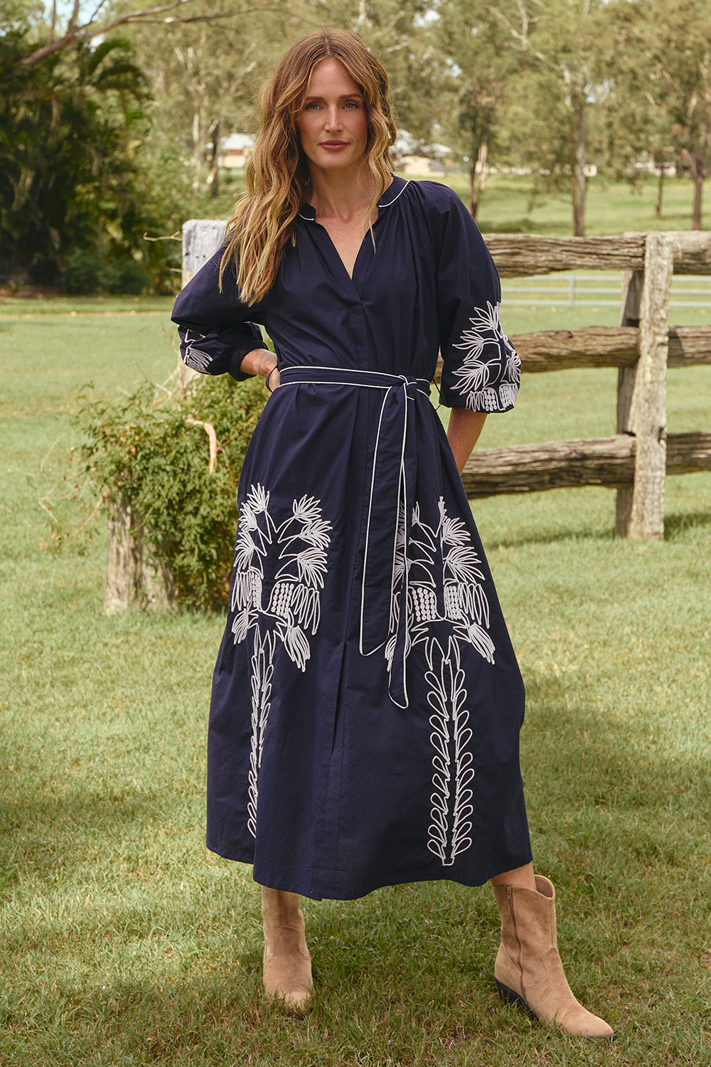 Model wearing the Robin Belted Dress in Inkwell Navy with split v-opening neckline, Adrift Clothing