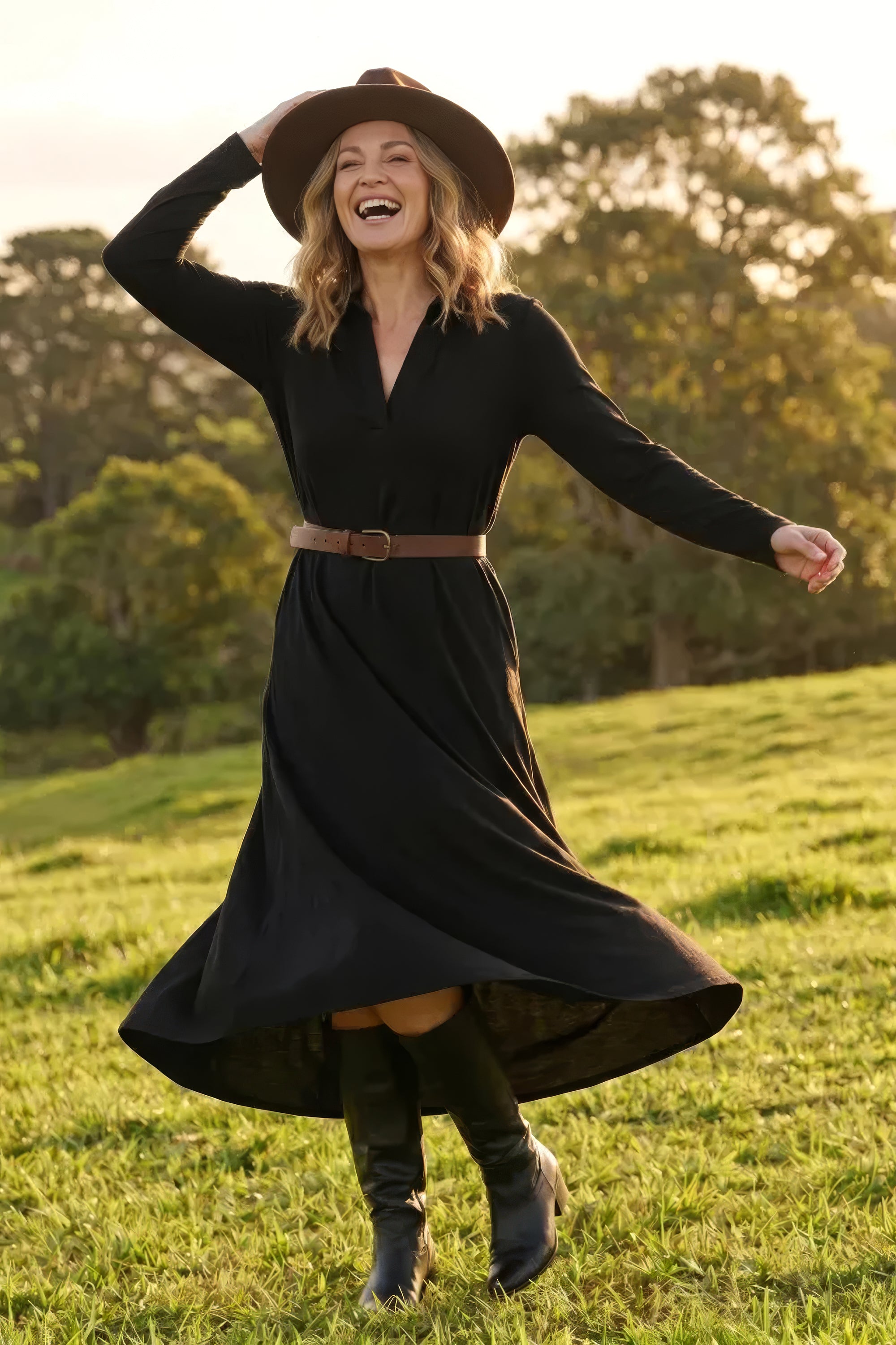 Model wearing the Collared Long Sleeve Swing Tee Dress in Black with swing hemline, Adrift Clothing