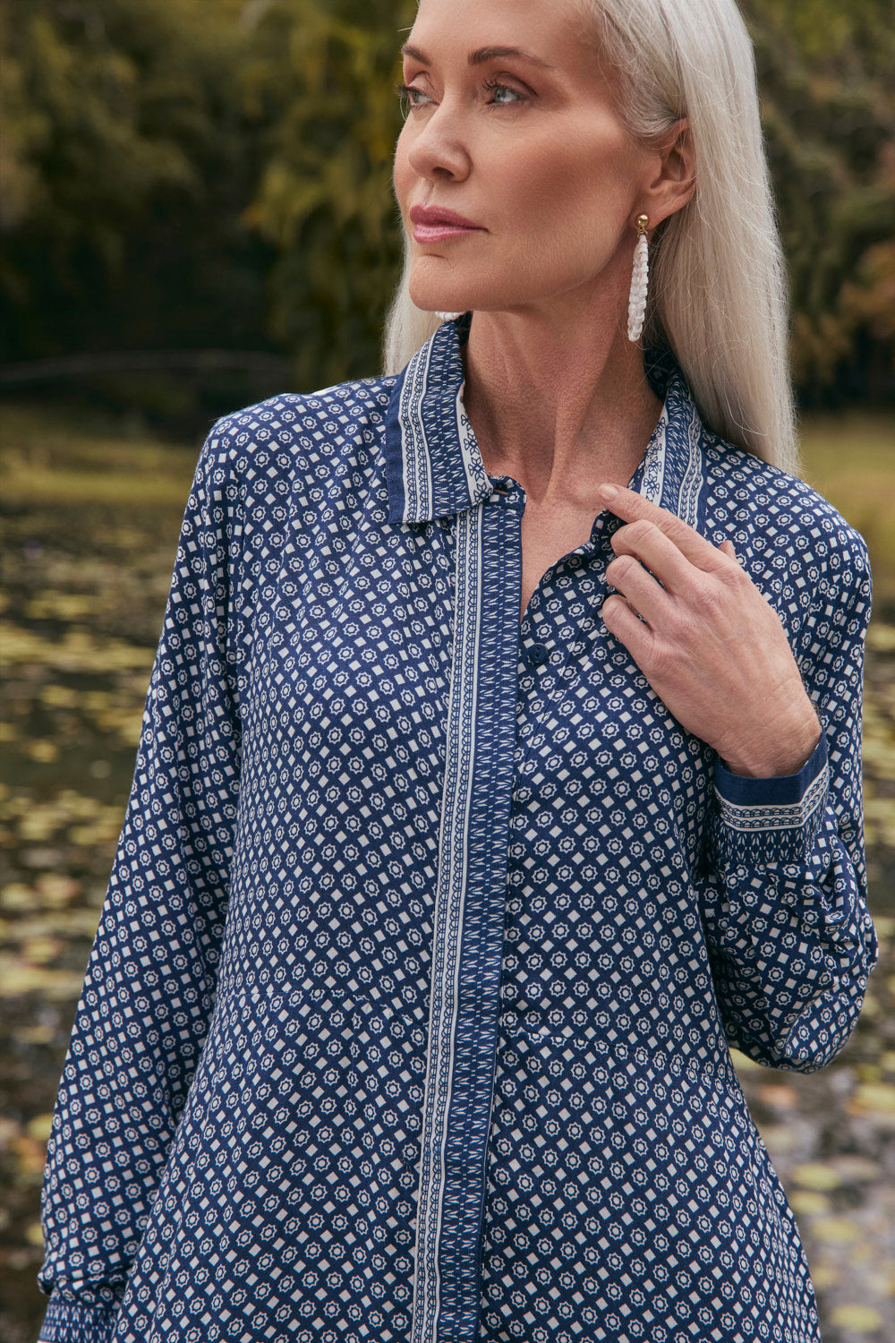 Woman wearing a blue patterned dress outdoors
