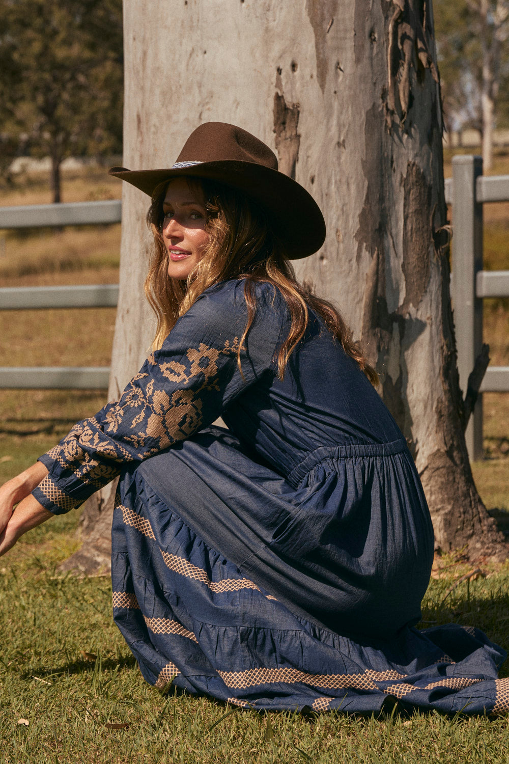 Model wearing the Tabitha Embroidered Chambray Dress in Mid Wash with raglan sleeves, Adrift Clothing